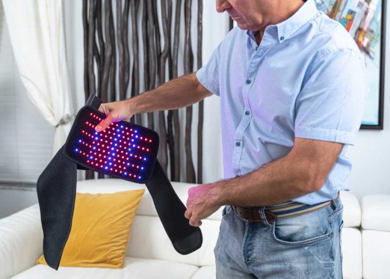 Person showing OnLux Lumbar Pad with the lights on.